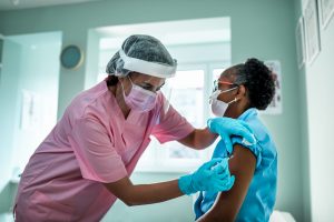 Support nurses - a picture of a nurse and giving a shot to a patient