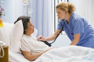 Nursing Career - a picture of a nurse listening to a patient's heart.