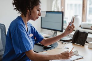 Remote Nursing Jobs- picture of a nurse on the phone taking notes 