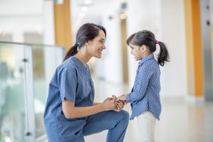 The 28 Most In-Demand Nursing Jobs of 2022 - a picture of a nurse greeting a young female patient.