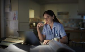 Studying Nursing - picture of a nurse studying in her room.