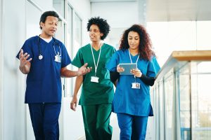 Conflict Resolution in Nursing: 3 nurses talking and walking