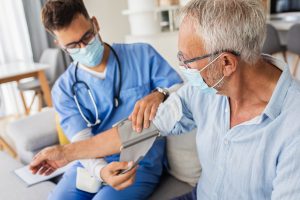 Home health nurse with patient