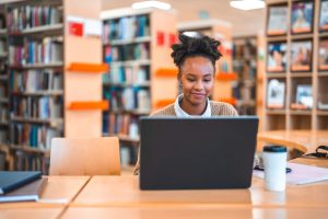 Nursing Resume Do's and Don'ts: How to Craft a Strong Resume - a picture of a student working at her computer.