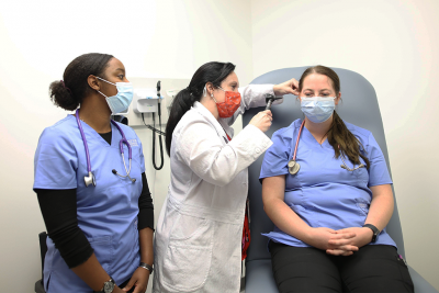 Nursing school students learning clinical skills