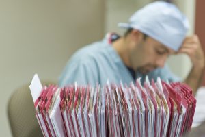 20 Things Prospective Nurses Need to Know a picture of a nurse and lots of folders