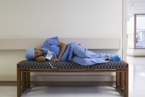 Why Become A Nurse - a picture of a nurse laying down tired
