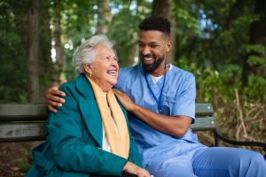 Nursing Quotes -- a picture of a RN laughing with an elderly patient.