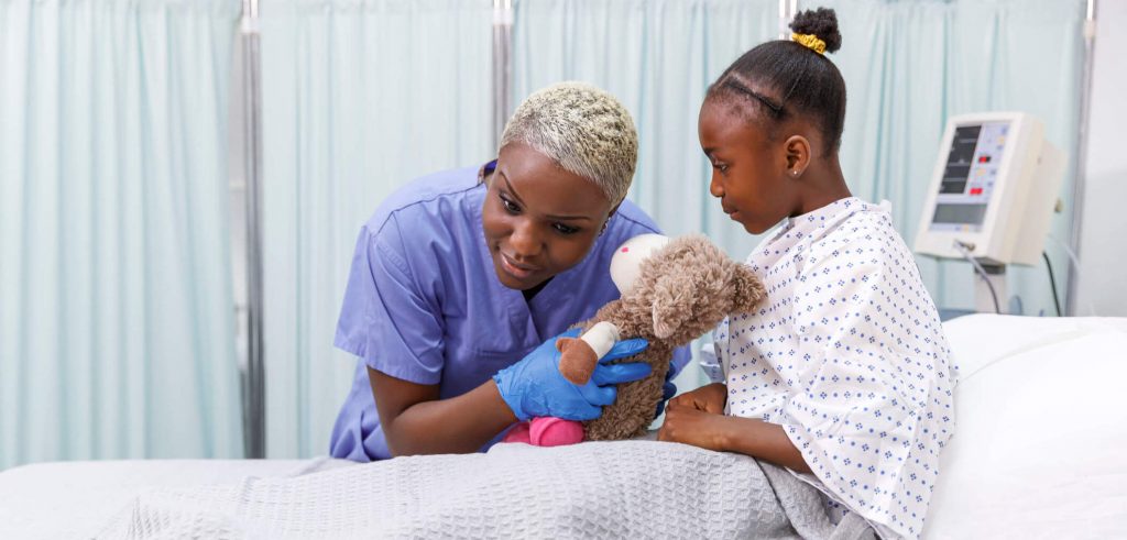 https://images.aspen.edu/wp/uploads/2022/08/Nursing-Quotes-a-picture-of-a-nurse-with-a-young-female-patient-examining-her-stuffed-animal-toy.-1-1024x491.jpg
