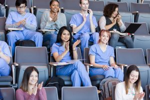 Nursing Quotes- a picture of a student nurses in class listening to a professor.