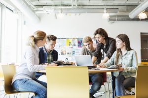 Building a Supportive Network - a picture of a teacher providing help to a study group of students.