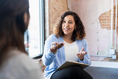 Feedback: The Currency of Success - a picture of a woman providing feedback.