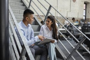 Feedback: The Currency of Success - a picture of a young male receiving feedback from a young female.