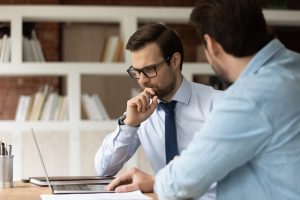 Feedback: The Currency of Success - a picture of a young male receiving feedback from another male.