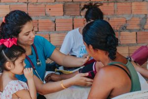 Tired of the Hospital? Career Alternatives for the Nursing Professional - a picture of a nurse checking a mother's blood pressure.