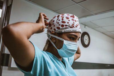 Tired of the Hospital? Career Alternatives for the Nursing Professional - a picture of a nurse putting on her COVID mask