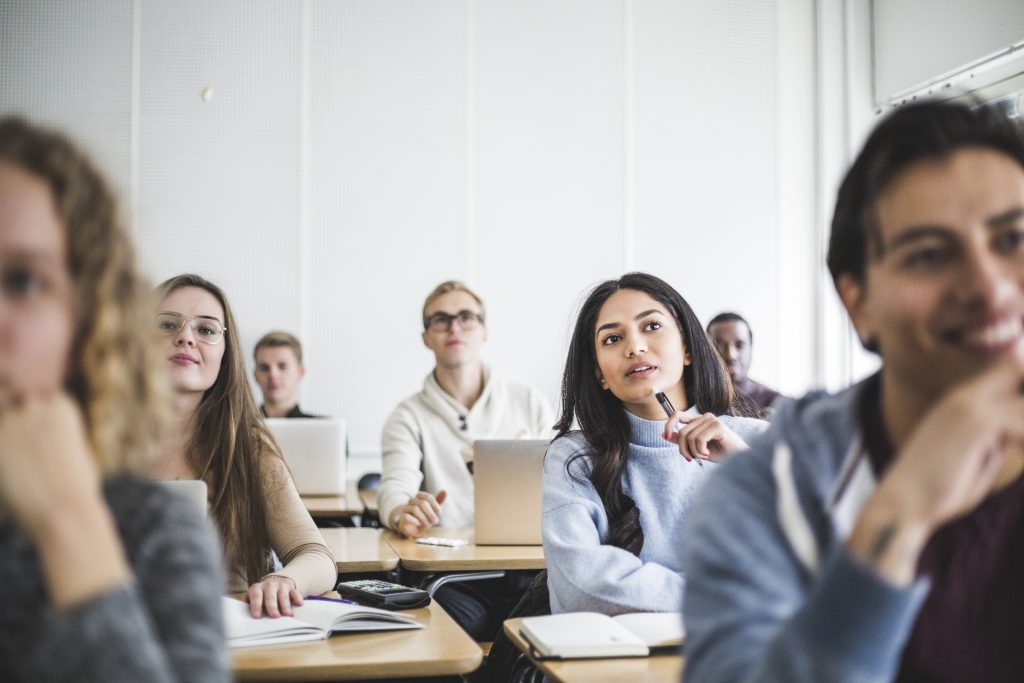 Unleash Your Genius- a picture of students paying attention in the classroom.