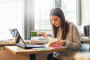 Master the Basics of APA - picture of a female student doing research