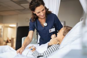 Float pool nurse- a picture of a nurse tending to a child in a hospital bed.