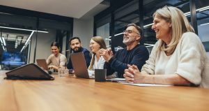 IRB: Friend or foe - a picture of 5 people sitting at a table together with laptops open.