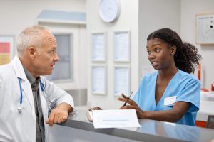Administrative Healthcare Career Guide - a picture of a healthcare administrator speaking with a doctor.