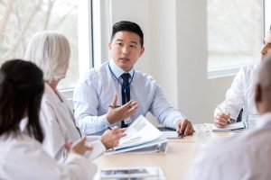 Administrative Healthcare Career Guide - a picture of a healthcare administrator speaking with doctors.