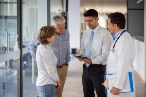 Administrative Healthcare Career Guide - a picture of an hospital manager speaking with patients.