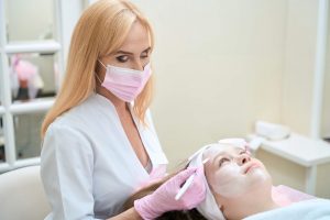 Aesthetics Nurse: A Comprehensive Guide - a picture of a nurse treating a female patient.