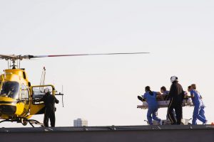  Flight nurse - a picture of nurses rushing to a helicopter with a patient on a stretcher. 