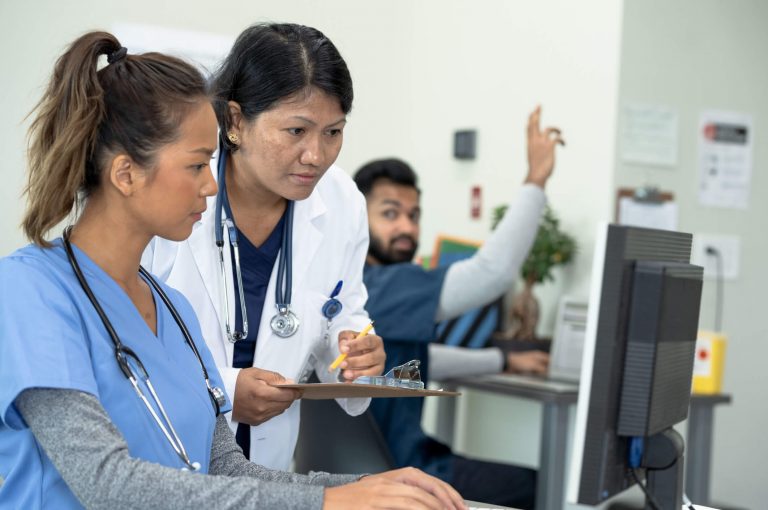 What Is A Nurse Educator How To Become One Aspen University   Nurse Teacher Aka Nurse Educator  The Complete Career Guide A Picture Of A Nurse Educator Checking A Students Work. 1 768x510 