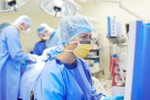 Scrub Nurse vs. Surgical Technologist: A Comprehensive Career Comparison - a picture of a nurse documenting during surgery.