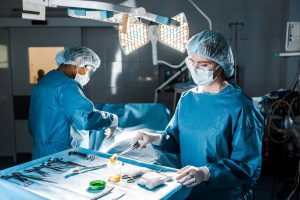 Scrub Nurse vs. Surgical Technologist: A Comprehensive Career Comparison - a picture of a nurse holding a gauze pad during surgery.