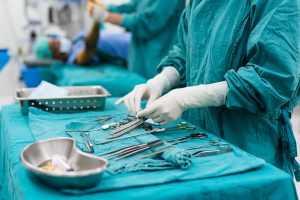 Scrub Nurse vs. Surgical Technologist: A Comprehensive Career Comparison  - a picture of surgical instruments and a nurse organizing them.