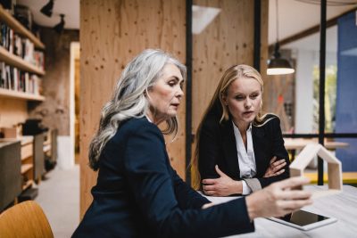 Learning to lead from the inside out - a picture of two business women sitting at a table. (1)